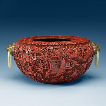 A large red lacquer censer/basin with bronze beast and nephrite ring handles, Qing dynasty, with Qianlong seal-mark.