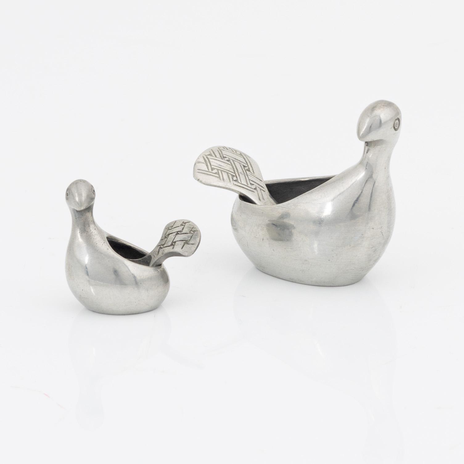 A pair of pewter salt containers by Lars Pirak, signed.