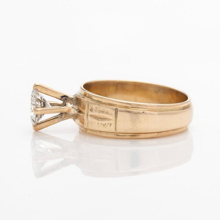A 14K gold ring, set with a brilliant-cut diamond.