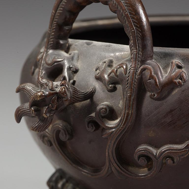 A bronze tripod censer with cover and stand, Qing dynasty, 17/18th Century.