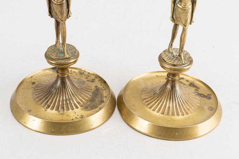 A pair of early 20th century brass candle sticks.