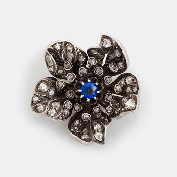 A silver and 14K gold brooch set with a blue stone and rose-cut diamonds.