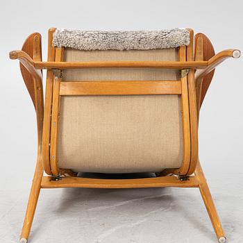 Yngve Ekström, an oak 'Lamino' easy chair with foot stool  for Swedese,