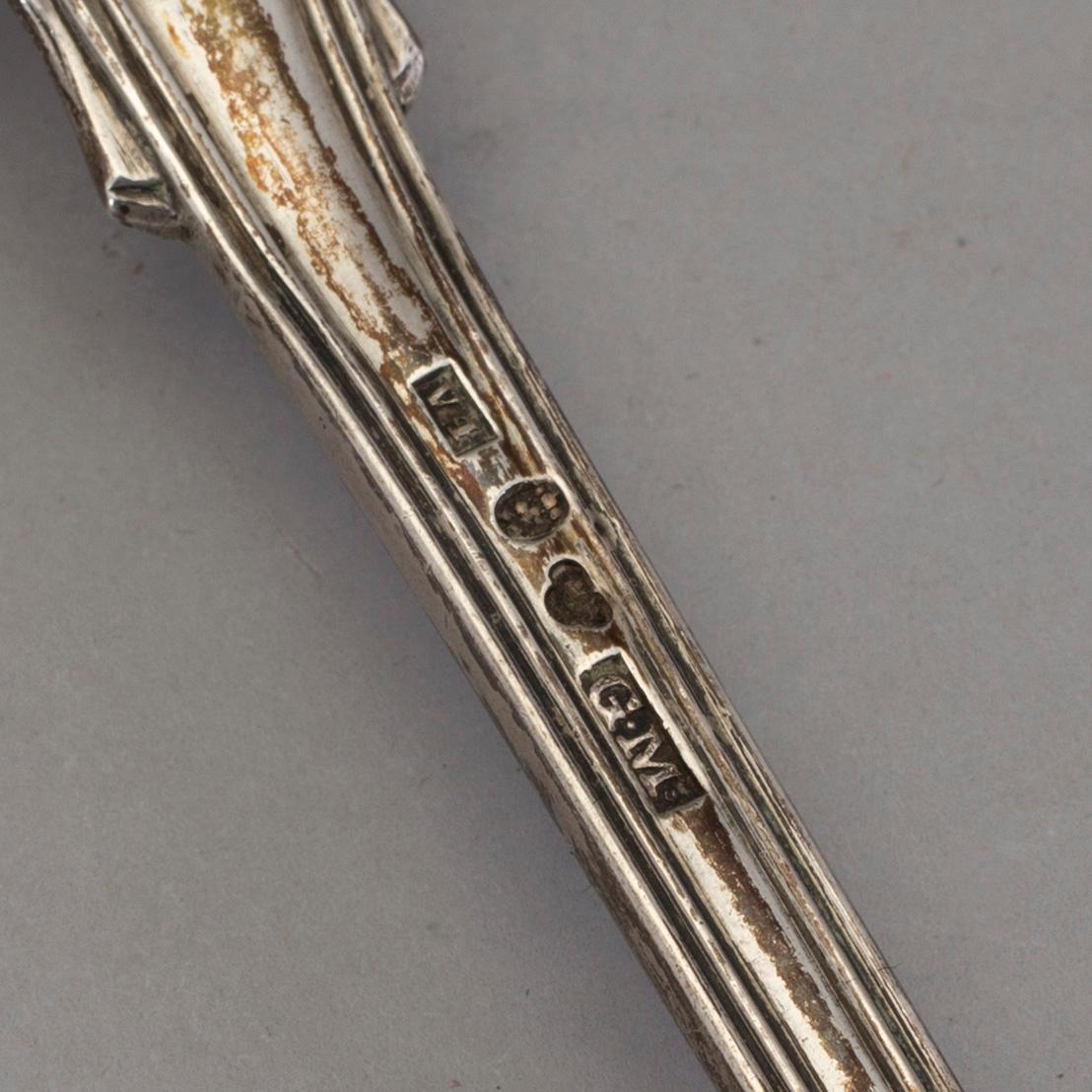 Four Swedish 19th-/20th century parcel-gilt caster-spoons and a sauce-spoon.