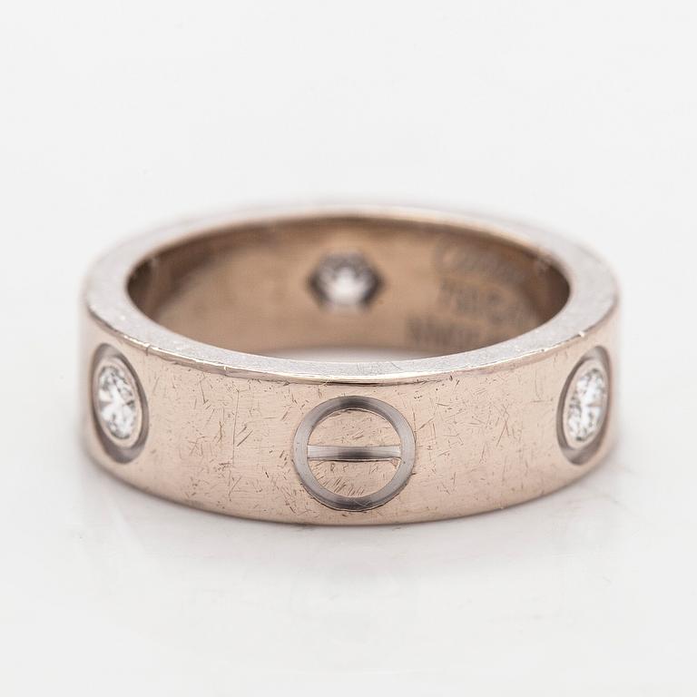 Cartier, an 18K white gold 'Love' ring with three brilliant-cut diamonds.