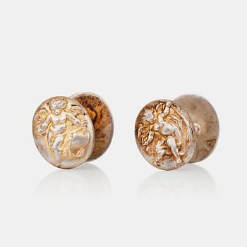 A pair of cherub motif cufflinks by Alfred Philips.