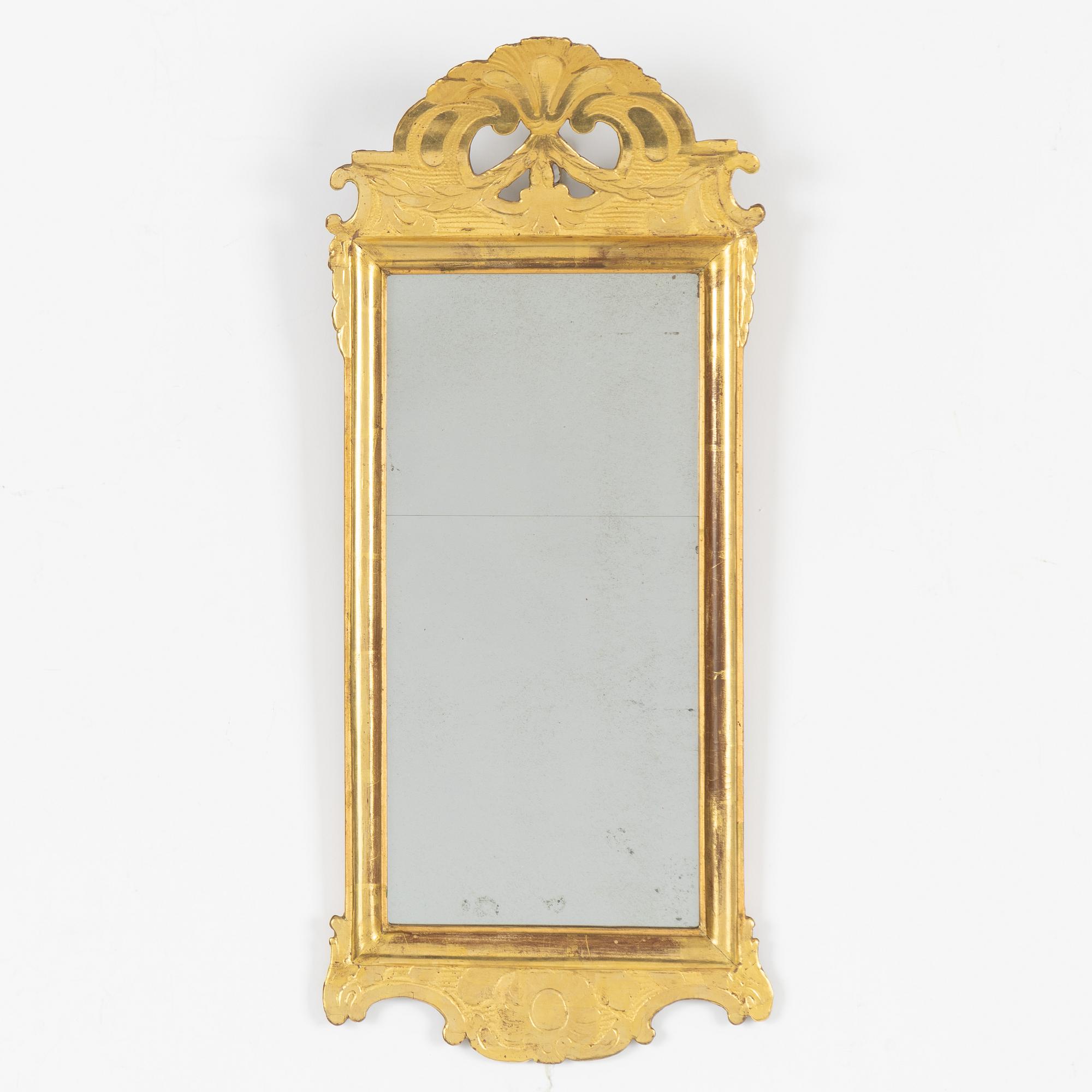 A giltwood rococo mirror by J. Schürer (master in Stockholm 1769).