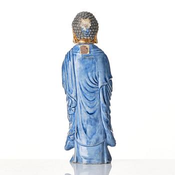 A porcelain figure of a standing Buddha, Qing dynasty, 18th Century.