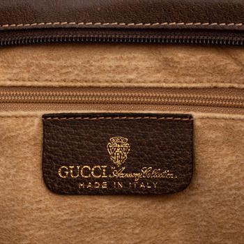 Gucci, a canvas handbag.