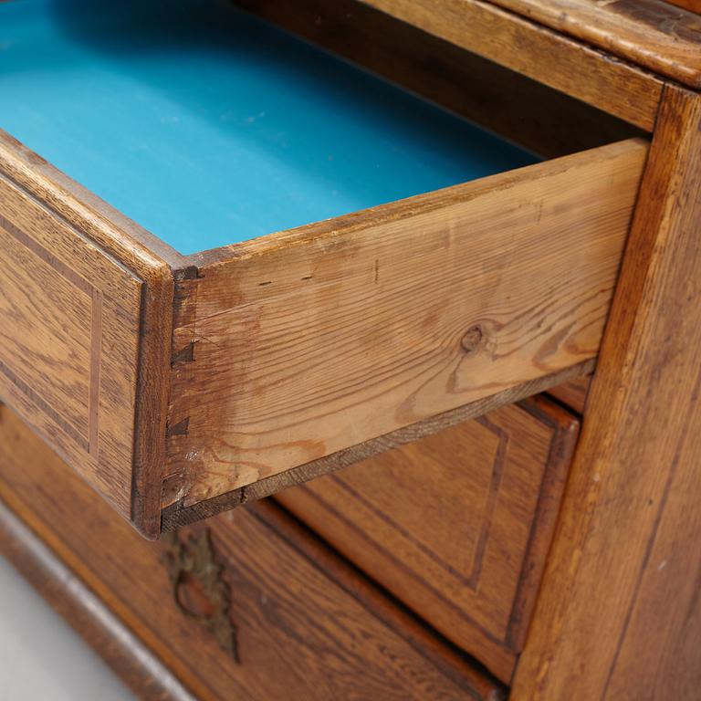 An oak rococo cabinet, mid 18th Century.