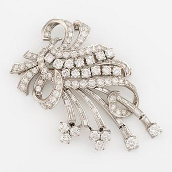 A platinum brooch with round brilliant and baguette-cut diamonds.