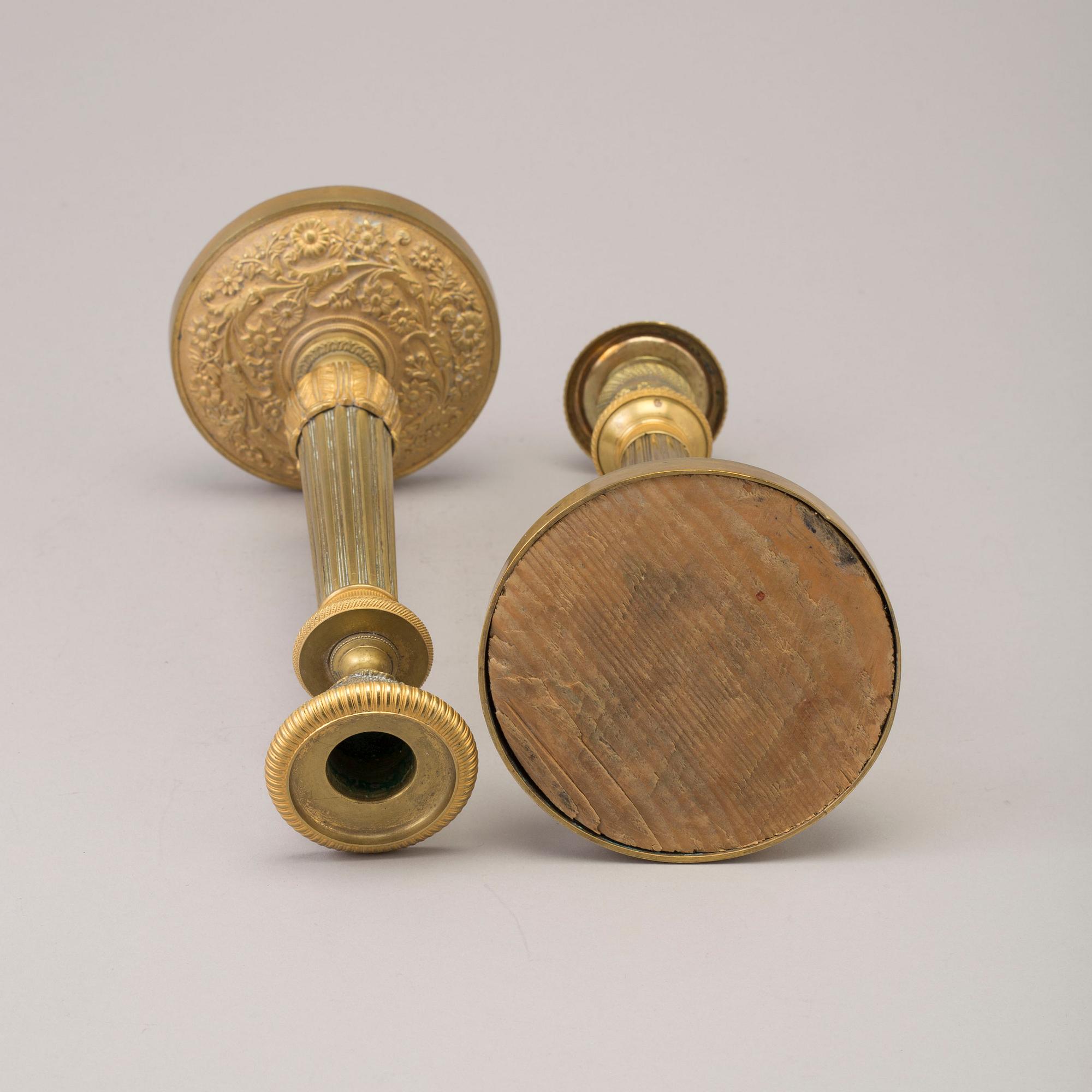 A pair of early 19th century ormolu candlesticks.