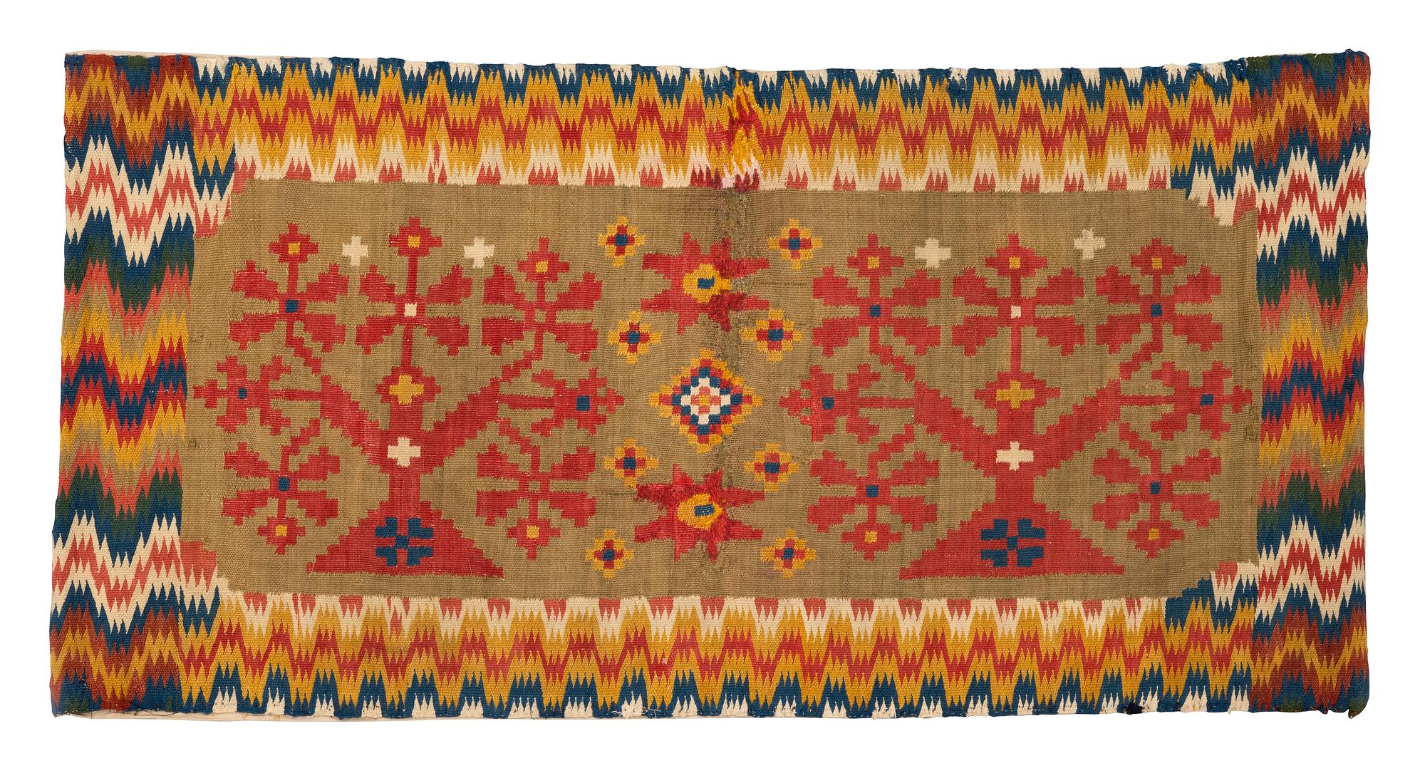 A carriage cushion, double-interlocked tapestry, ca 50 x 99,5 cm, Scania, (Sweden), first half of the 19th century.