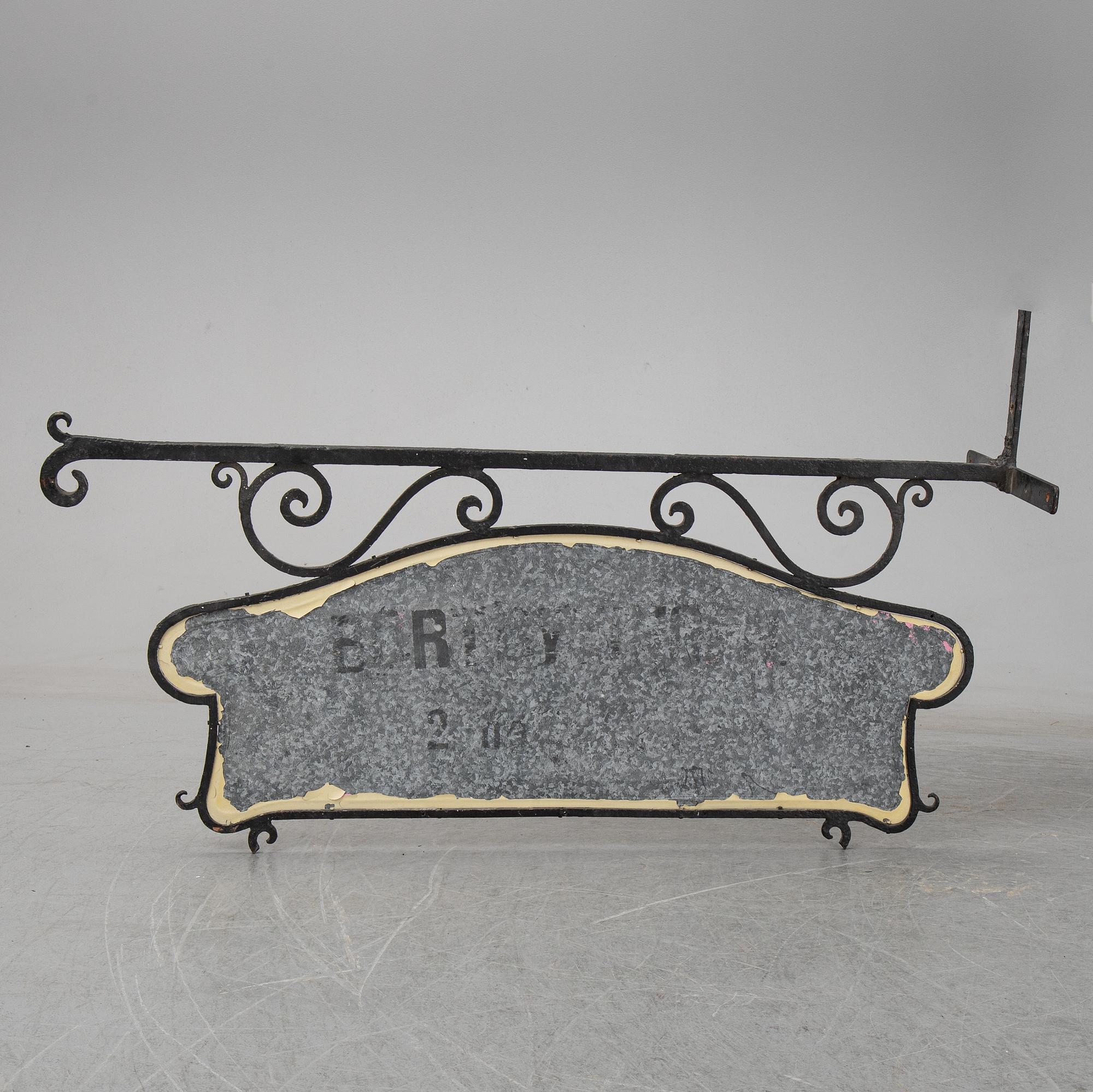 A wrought iron shop sign, 20th Century.