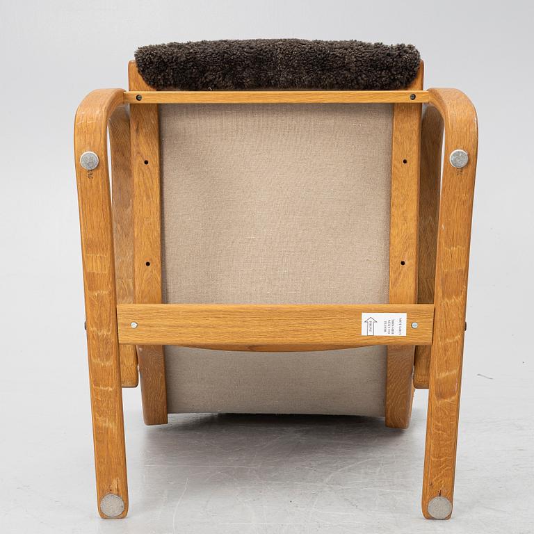 Jan Ekström, a "Gazell" armchair with a footstool, 21st century.