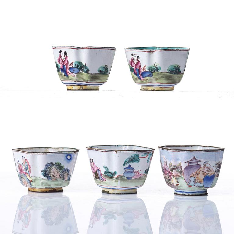 A set of five enamel on copper tea cups and a dish, Qing dynasty, circa 1800.