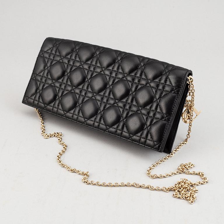 Christian Dior, a quilted leather handbag/clutch.