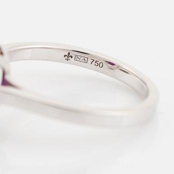 An 18K white gold ring set with a faceted ruby.