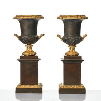 A pair of French Louis Philippe gilt and patinated bronze urns, first part 19th century.