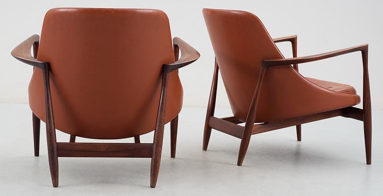 A pair of Ib Kofod Larsen 'Elisabeth' palisander and brown leather easy chairs.