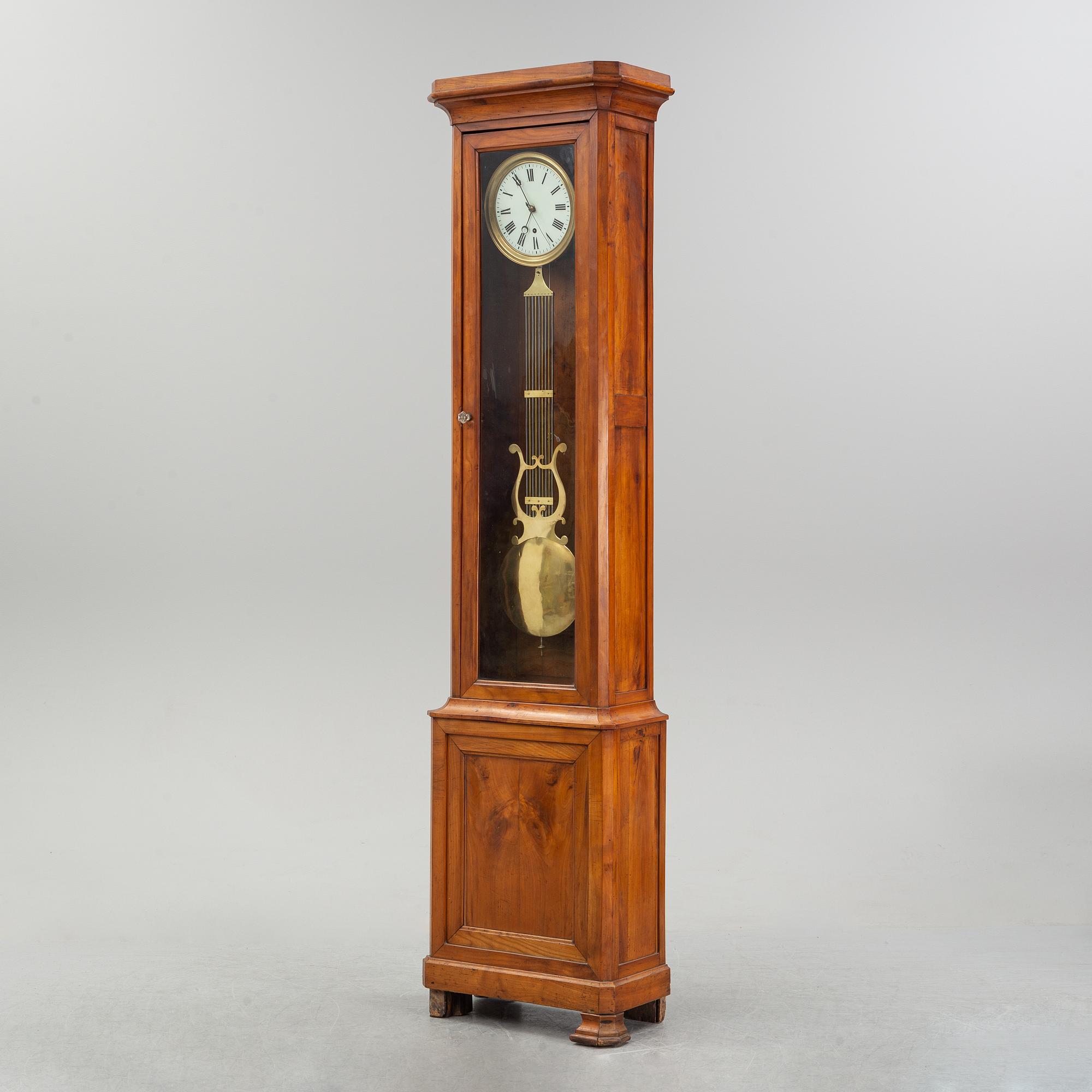 A walnut long case clock, from around the year 1900.