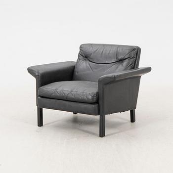 A 1960/70s Hans Olsen leather armchair.