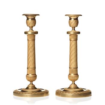 124. A pair of Empire candlesticks.