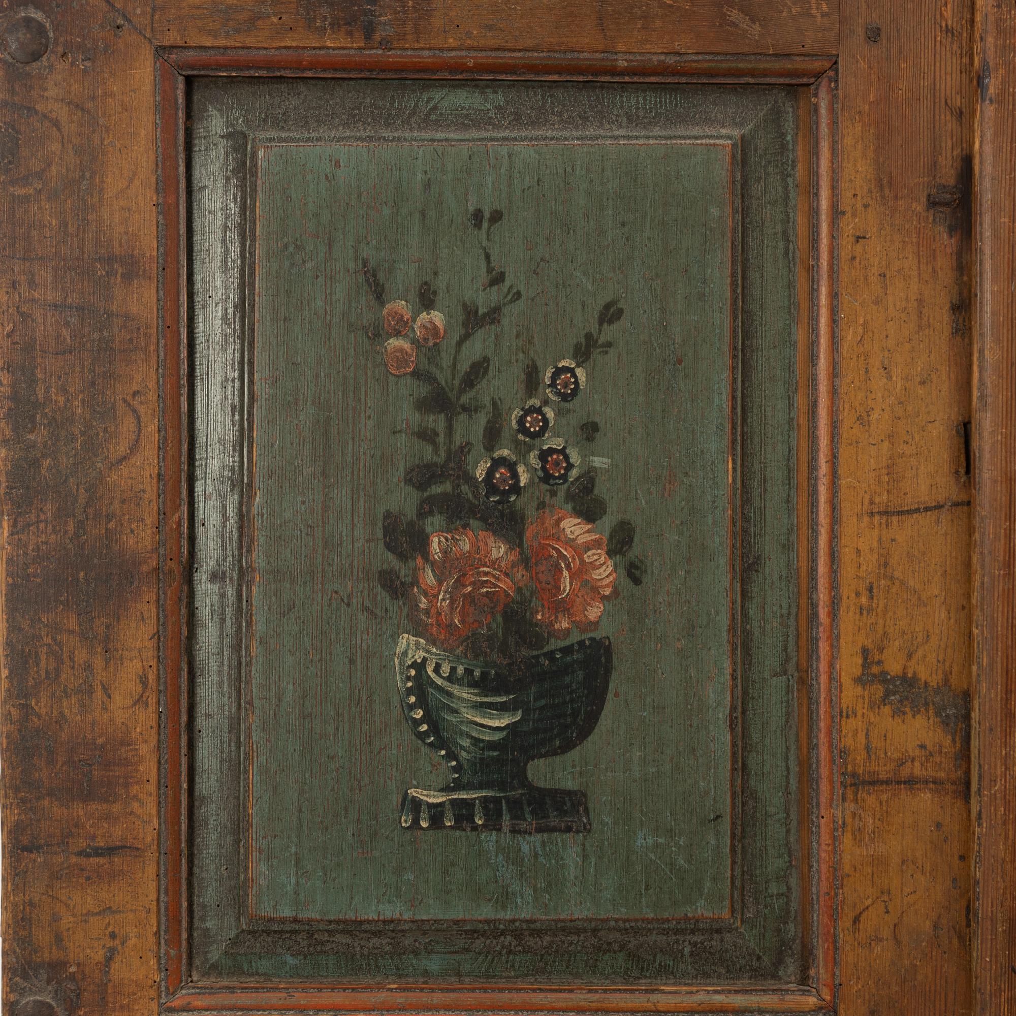 A pair of folk-art cabinet doors mounted as a painting, first part 19th century.