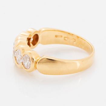 An 18K gold ring set with a heart formed brilliant-cut diamond.