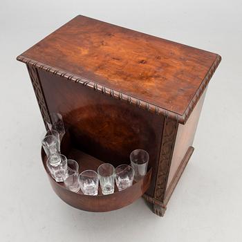 A WOODEN BAR CABINET.