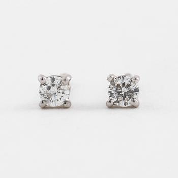 A pair of brilliant cut diamond earrings.