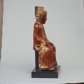 A seated, gilded and lacquered wooden scultpure of a mandarin official, Qing dynasty, 19th Century.