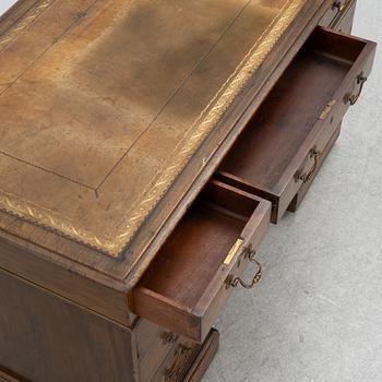 A mahogany and mahogany veneer desk with desk chair, 20th Century.