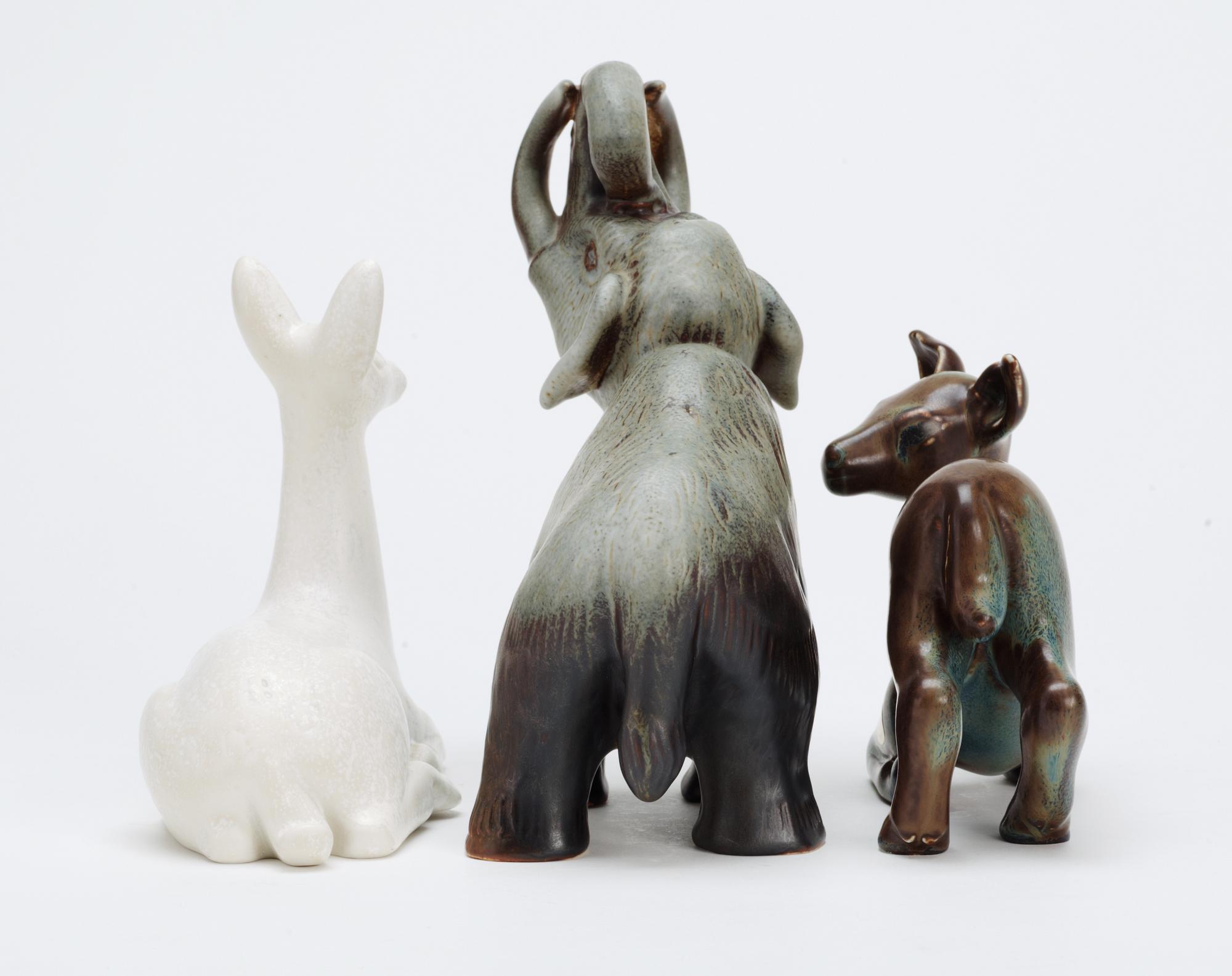 Three Gunnar Nylund stoneware figures, two deer and a mammoth, Rörstrand.