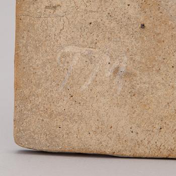 A stoneware art plate signed TM.