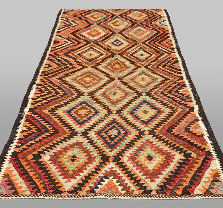 A  Persian nomadic Kilim rug, approx. 300 x 143 cm.