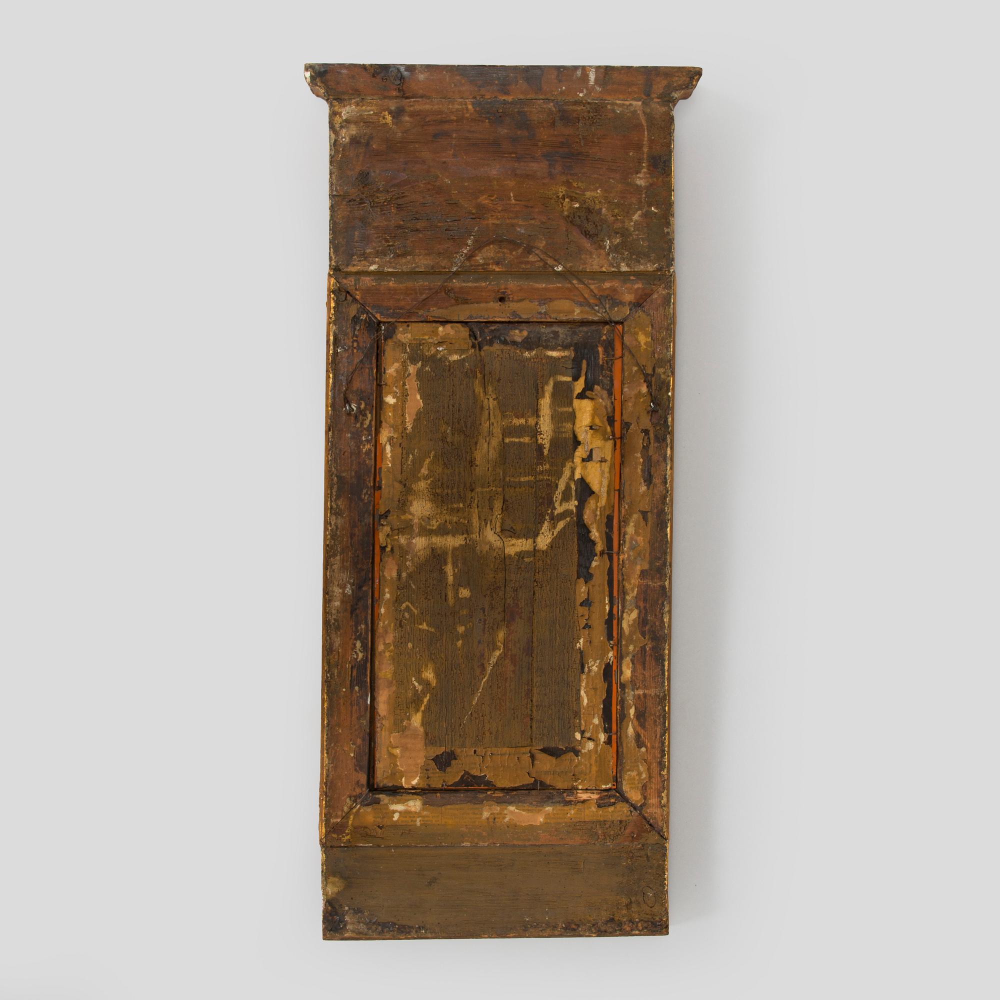 A gilded and bronzed Empire mirror, first half of the 19th century.