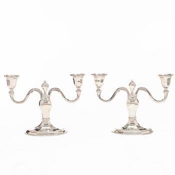 A pair of silver candelabras, with Swedish import marks, possibly mid20th century.