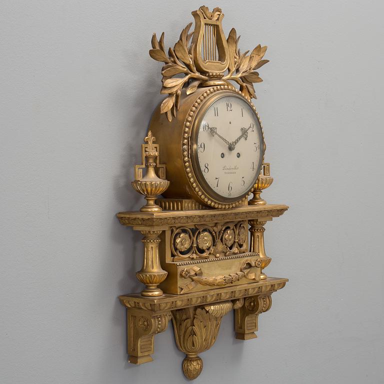 A Swedish Gustavian style gilt wood wall clock, marked Linderoth Stockholm, 20th century.