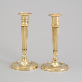 A pair of early 19th century bronze candlesticks.