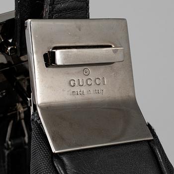 GUCCI, a canvas handbag.