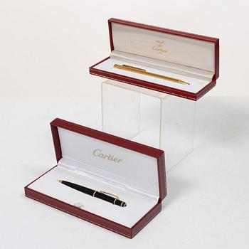 Cartier, Two ballpoint pens, 'must de Cartier' and 'Diabolo de Cartier'.