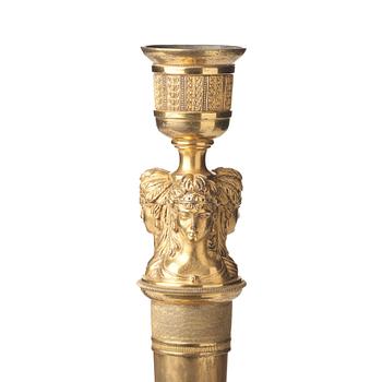 A pair of French Empire early 19th century gilt bronze candlesticks.