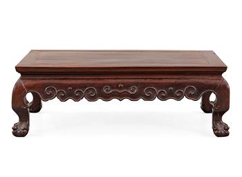 1673. A hardwood 'claw on ball' low table, Qing dynasty.