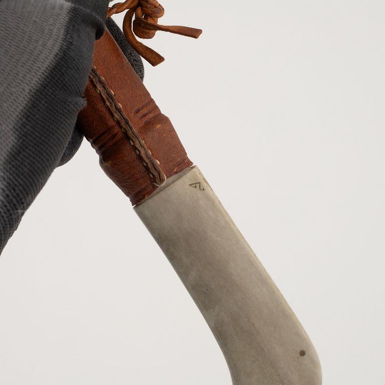 A reindeer horn knife, signed.