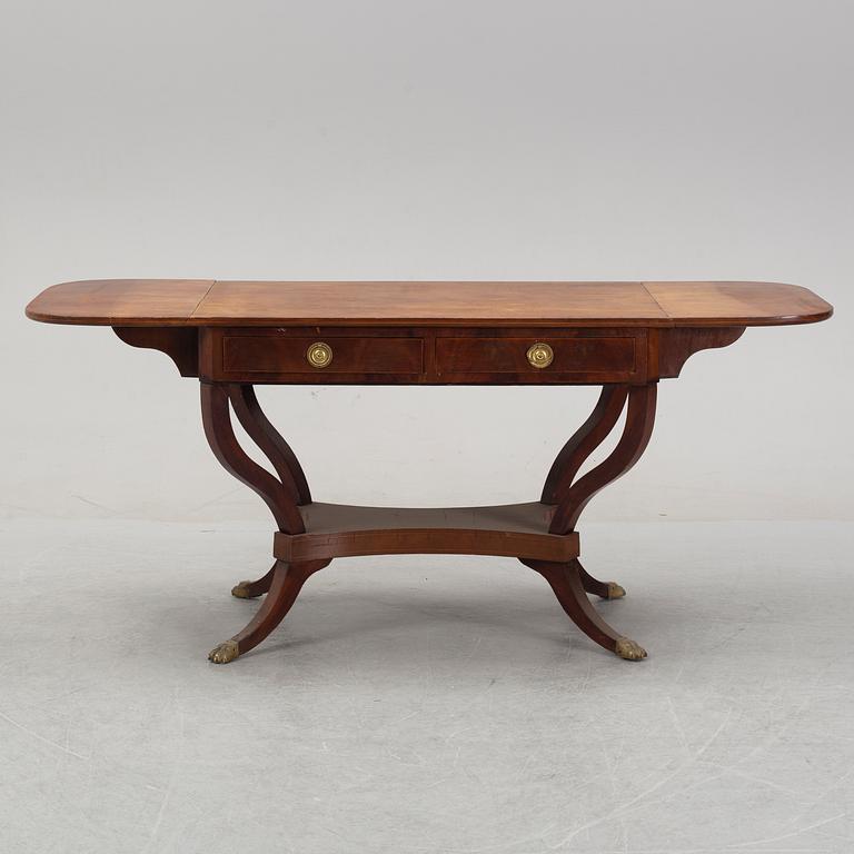 An Empire style mahogany  center table from around the year 1900.