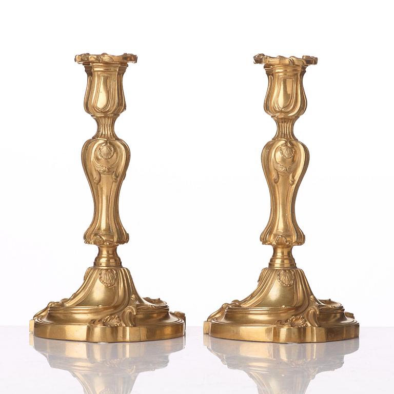 A pair of French Louis XV mid 18th century gilt bronze candlesticks.