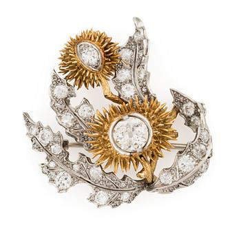 591. A platinum and 18K gold brooch with an old-cut diamond approximately 1.50 cts.