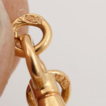 An 18K gold locket set with rose-cut diamonds.
