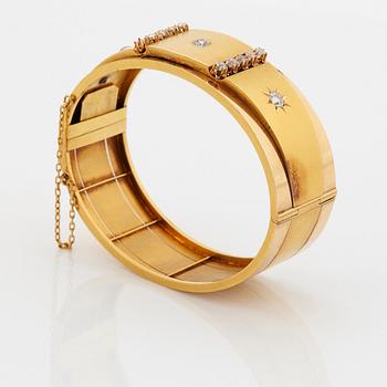 An 18K gold bracelet set with old-cut diamonds.